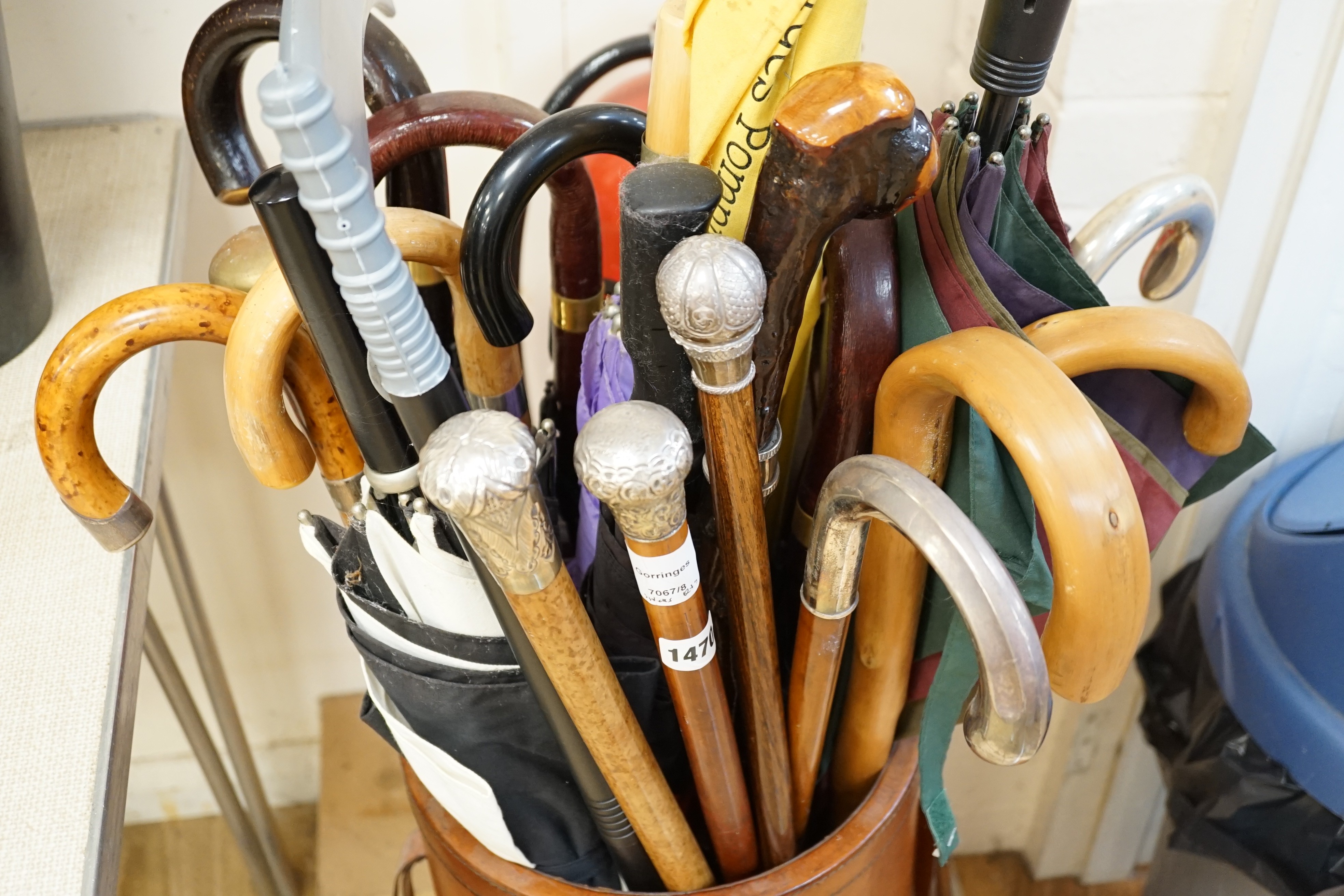 Four assorted white metal mounted walking sticks, sundry walking sticks, umbrellas and canes